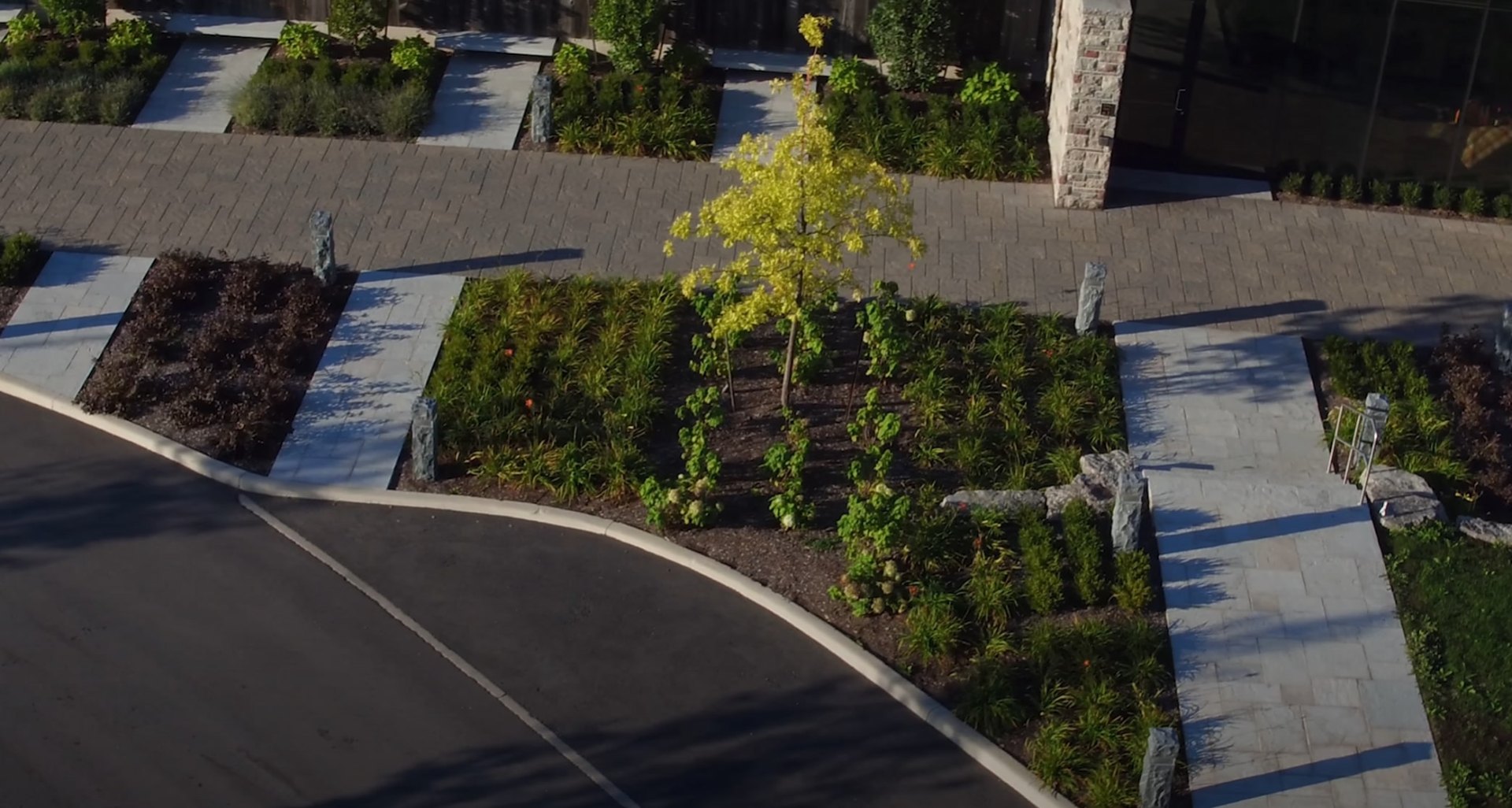 Commercial Landscape Architecture Aerial view of modern commercial landscape design with geometric planting beds and structured hardscaping elements