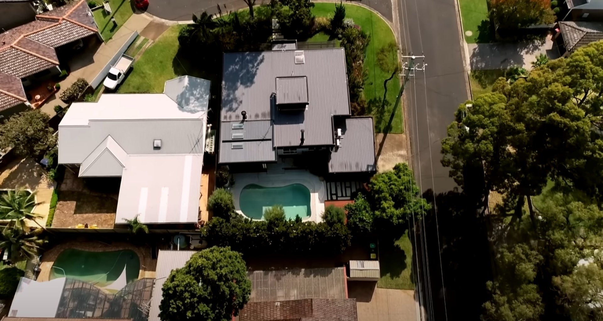 Bird's eye view of complete landscape design with pool and outdoor living spaces Aerial view of residential property showing pool, landscaping, and outdoor entertainment areas