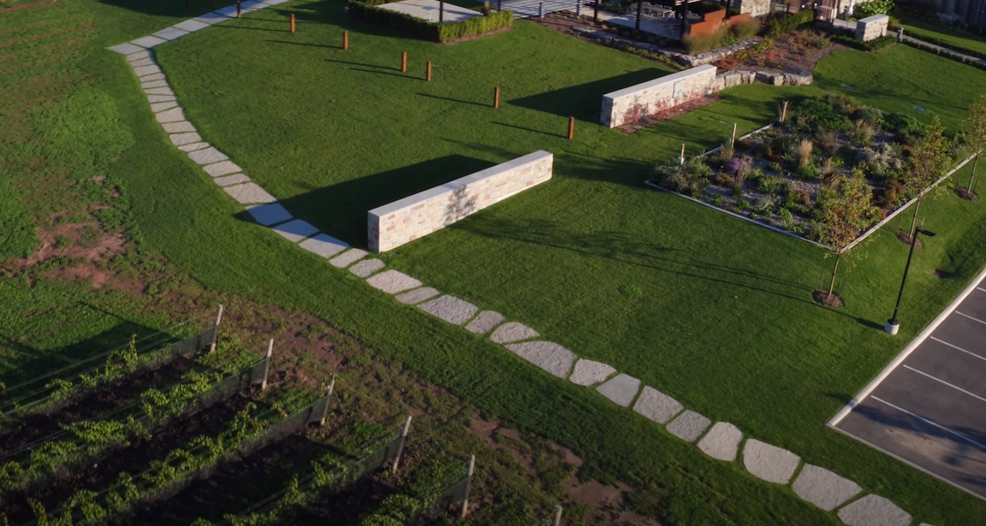 Contemporary landscape architecture featuring clean lines and structured plantings Aerial view of modern landscape design with stone pathways and geometric garden beds